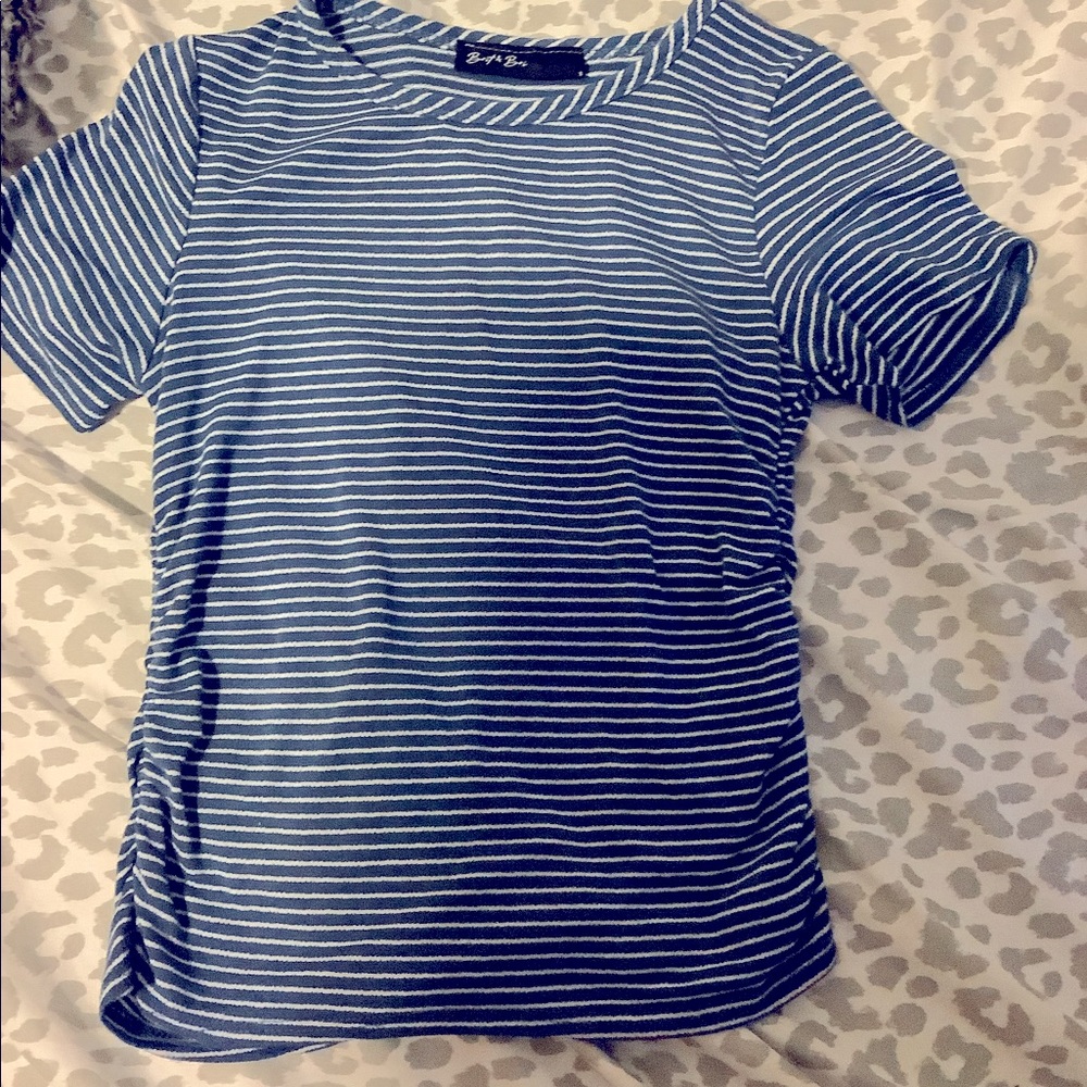 This T-shirt is tight on On the sides and has blue and white stripes.
